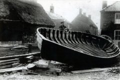 Mr Kirby building a boat . At Black Street in front of Fairview House. C1900